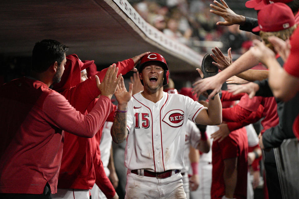 Cincinnati Reds' Nick Senzel (15) celebrates with teammates after scoring on a Joey Votto single in the seventh inning of a baseball game against the Minnesota Twins in Cincinnati, Monday, Sept. 18, 2023. (AP Photo/Jeff Dean)
