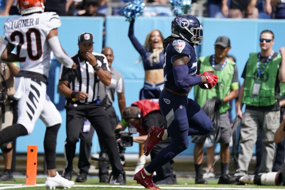 Tennessee Titans running back Derrick Henry runs into the end zone for a touchdown against Cincinnati Bengals cornerback DJ Turner II during the first half of an NFL football game, Sunday, Oct. 1, 2023, in Nashville, Tenn. (AP Photo/George Walker IV)