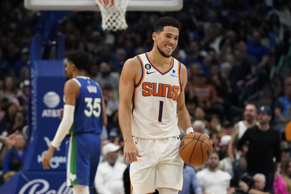 Phoenix Suns guard Devin Booker (1) reacts to a foul called against him during the fourth quarter of an NBA basketball game against the Dallas Mavericks in Dallas, Monday, Dec. 5, 2022. The Mavericks won 130-111. (AP Photo/LM Otero)