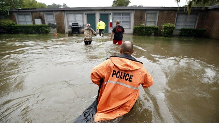 Volunteers assist police in making welfare checks on flooded homes on Aug. 28, 2017, in Dickinson, south of Houston, in the wake of Hurricane Harvey.