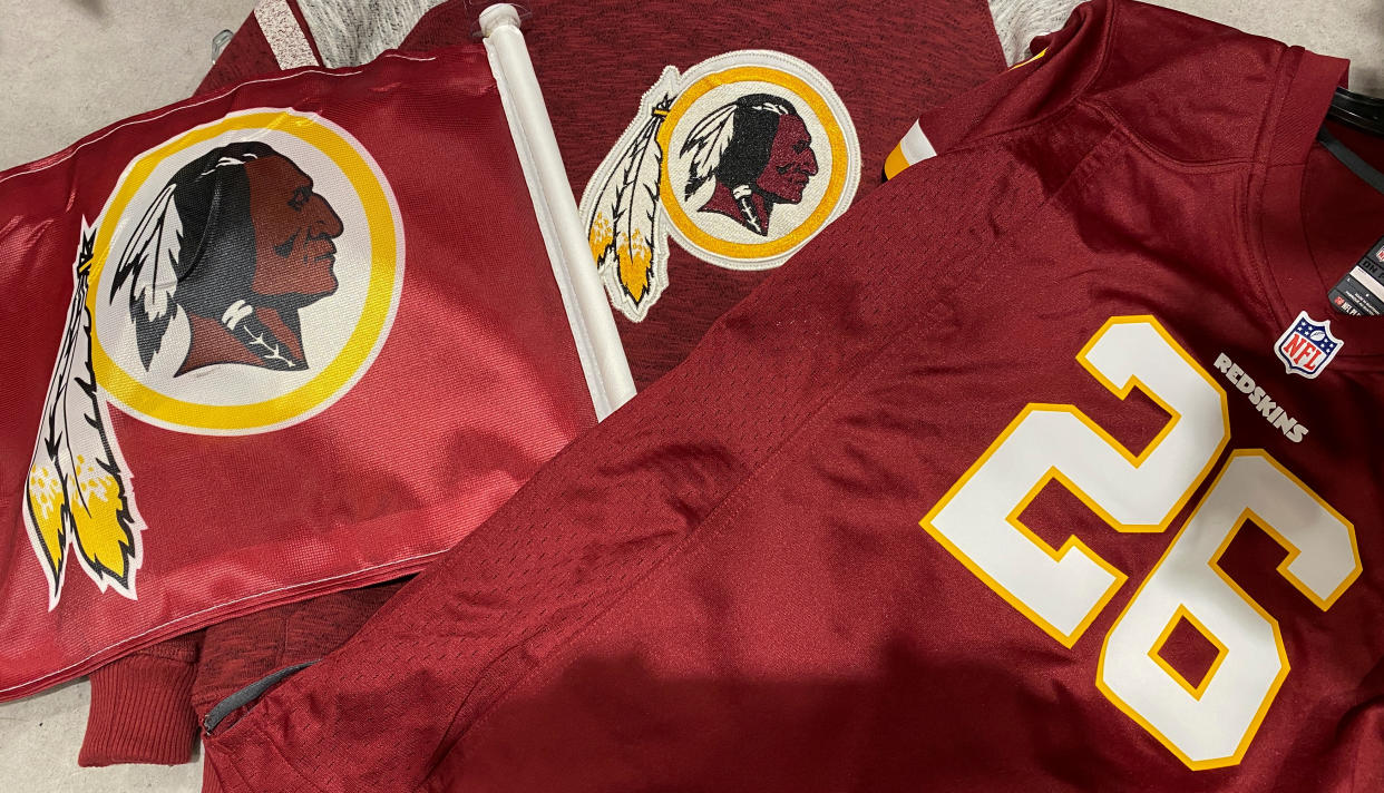 Washington Redskins football shirts and a team flag on sale at a sporting goods store in Bailey's Crossroads, Virginia, U.S., June 24, 2020.  REUTERS/Kevin Lamarque