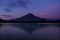 Mount Fuji and the morning sky are reflected in the water Wednesday, Aug. 7, 2019, in Lake Kawaguchi, west of Tokyo. (AP Photo/Jae C. Hong)