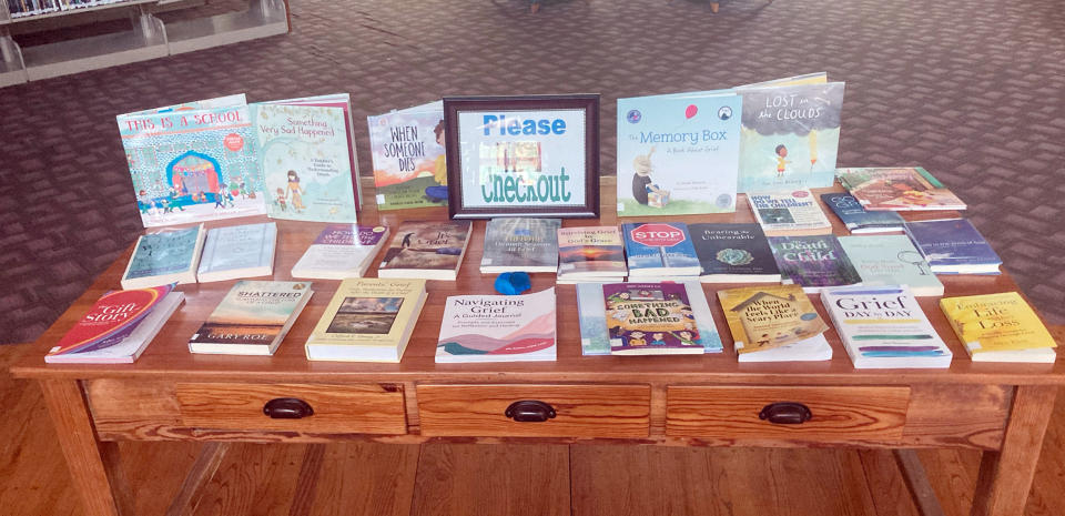 A photograph of a table set up to showcase books on grief, healing and life after loss. (Courtesy of Mendell Morgan)