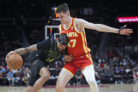 New Orleans Pelicans forward Brandon Ingram (14) tries to get around Atlanta Hawks guard Vit Krejci (27) during the first half of an NBA basketball game Sunday, March 10, 2024, in Atlanta. (AP Photo/John Bazemore)