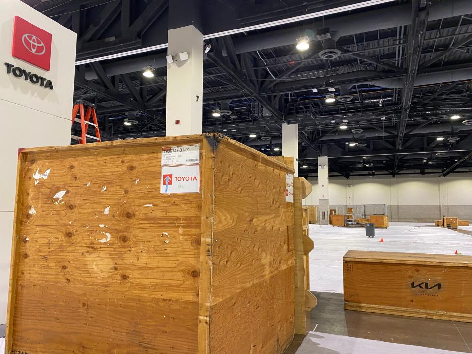 Most displays for the Northeast International Auto Show at the Rhode Island Convention Center were still in pieces in shipping crates Tuesday afternoon, although one Toyota sign had been assembled. The show opens Friday.
