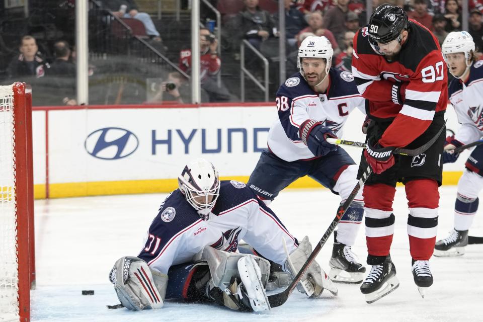 New Jersey Devils left wing Tomas Tatar (90) scores a goal past Columbus Blue Jackets goaltender Michael Hutchinson during the second period of an NHL hockey game Thursday, April 6, 2023, in Newark, N.J. (AP Photo/Mary Altaffer)
