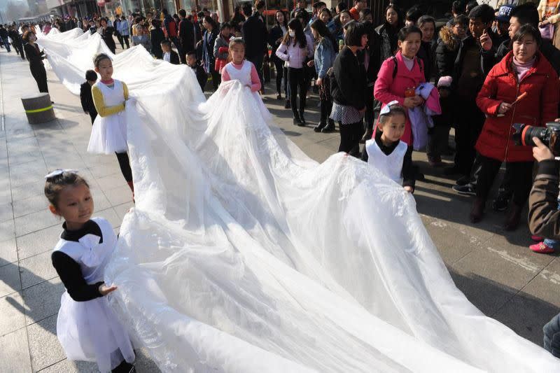 The wedding dress train being carried by little kids. (Photo: That’s China/Facebook)