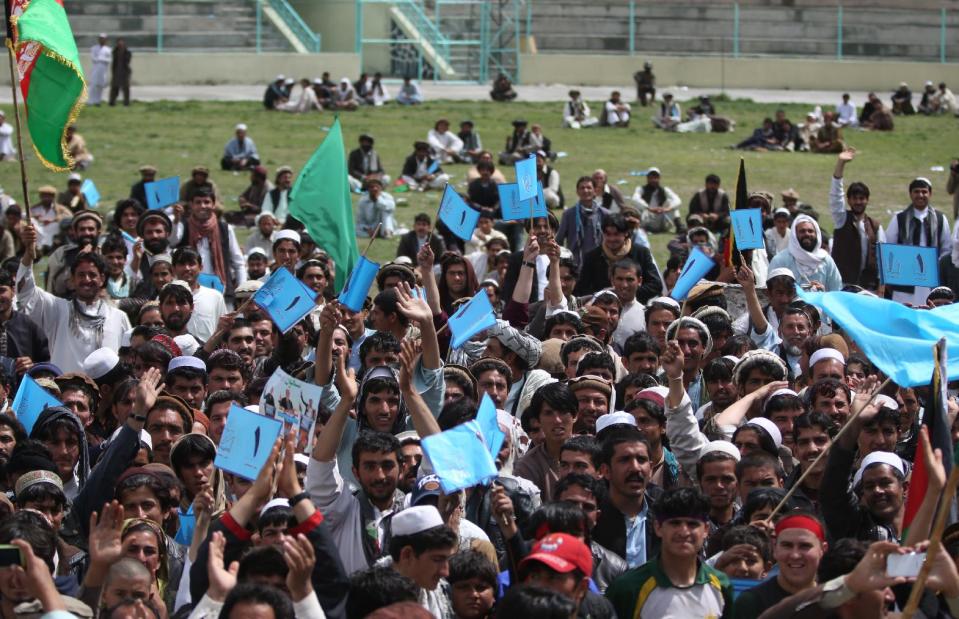 In this photo taken on Saturday, March 29, 2014, supporters of Afghanistan presidential candidate and former foreign minister Abdullah Abdullah, listen to his speech during a campaign rally in Khost city, Afghanistan. (AP Photo/Massoud Hossaini)