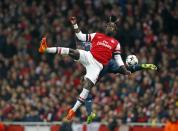 Arsenal's Bacary Sagna (front) collides with Bayern Munich's David Alaba during their Champions League round of 16 first leg soccer match at the Emirates Stadium in London, in this February 19, 2014 file photo. REUTERS/Darren Staples/Files (BRITAIN - Tags: SPORT SOCCER TPX IMAGES OF THE DAY)