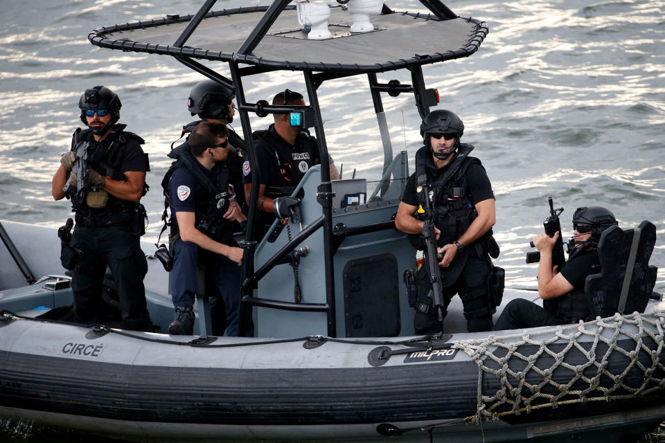 <p>French police officers on a dinghy escort U.S. First Lady and French President’s wife during their boat trop down the river Seine in Paris, on July 13, 2017. (Photo: Geoffroy Van Der Hasselt/AFP/Getty Images) </p>