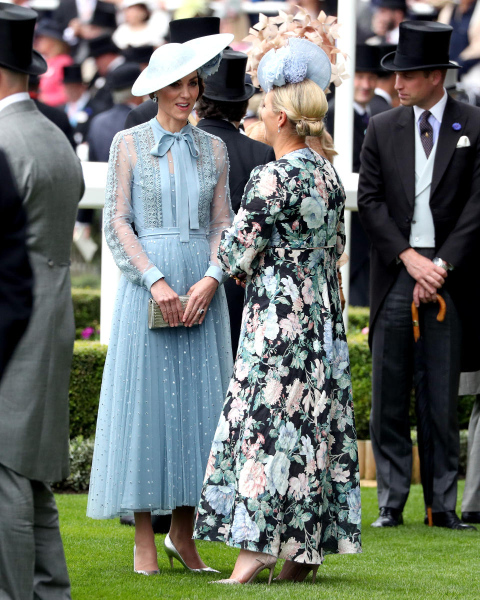 The Duchess of Cambridge (left) speaks to Zara Tindall whilst attending day one of Royal Ascot at Ascot Racecourse.