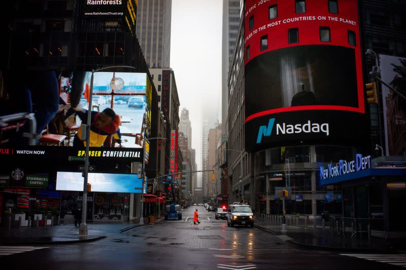 FILE PHOTO: A man walks near Nasdaq MarketSite in an empty Times Square