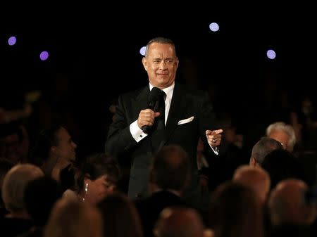 Actor Tom Hanks speaks while standing amid the audience at the 8th Annual Governors Awards in Los Angeles, California, U.S., November 12, 2016. REUTERS/Mario Anzuoni