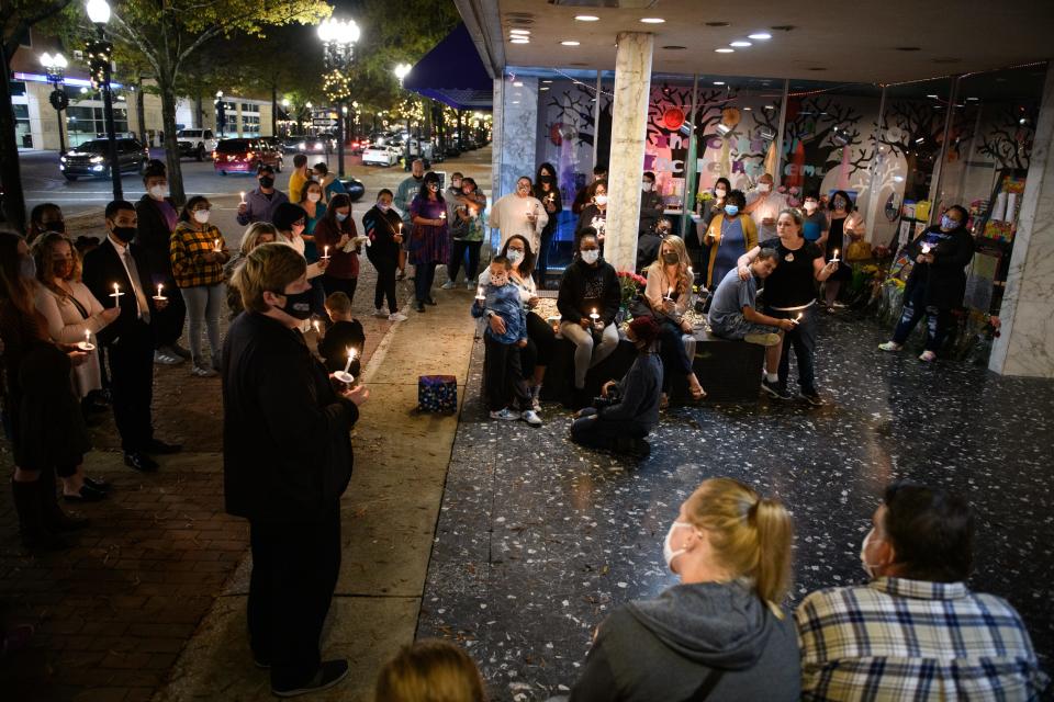 Friends, family and coworkers hold a candlelight vigil for Mary Ward, a teacher who died from COVID-19, at Capitol Encore Academy on Friday, Nov. 13, 2020.