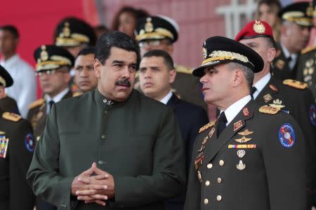 Venezuela's President Nicolas Maduro (L) speaks with Venezuela's Defense Minister Vladimir Padrino Lopez during an event for the transmission of military commands in Caracas, Venezuela June 23, 2017. Miraflores Palace/Handout via REUTERS