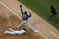 Minnesota Twins first baseman Willians Astudillo (64) catches the throw to double off Chicago White Sox's Adam Eaton (12) at first base during the first inning of a baseball game Tuesday, May 11, 2021, in Chicago. (AP Photo/Paul Beaty)