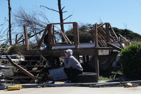 A woman sits outside a destroyed home after two deadly back-to-back tornadoes, in Beauregard, Alabama, U.S., March 5, 2019. REUTERS/Shannon Stapleton