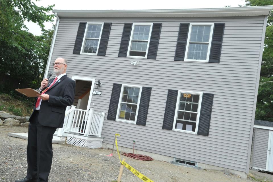 The Rev. Steven Aucella, of New North Church in Hingham, blesses the two new Habitat for Humanity homes.