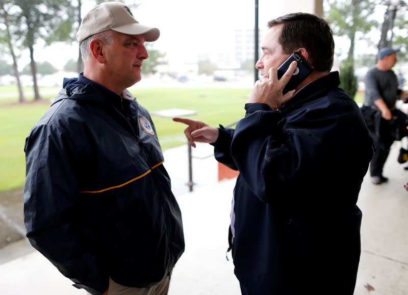 FILE PHOTO: Louisiana Governor John Bel Edwards (L) and Lt. Governor Billy Nungesser talk as Tropical Storm Harvey approaches the area in Lake Charles