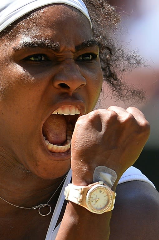 Serena Williams celebrates winning the first set against Garbine Muguruza during the women's singles final during the Wimbledon Championships at The All England Tennis Club in southwest London, on July 11, 2015