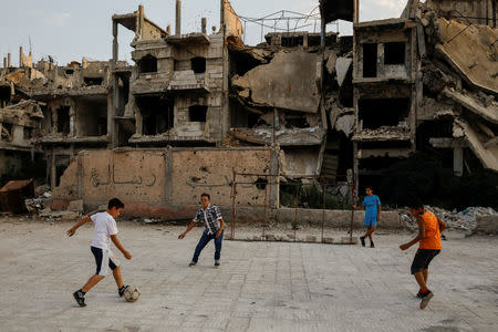 Children play soccer in al-Khalidiya area, in the government-controlled part of Homs, Syria, September 18, 2018. REUTERS/Marko Djurica