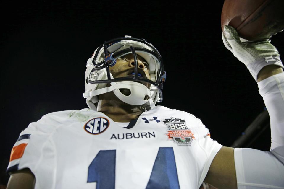 Auburn's Nick Marshall celebrates his touchdown run during the first half of the NCAA BCS National Championship college football game against Florida State Monday, Jan. 6, 2014, in Pasadena, Calif. (AP Photo/David J. Phillip)