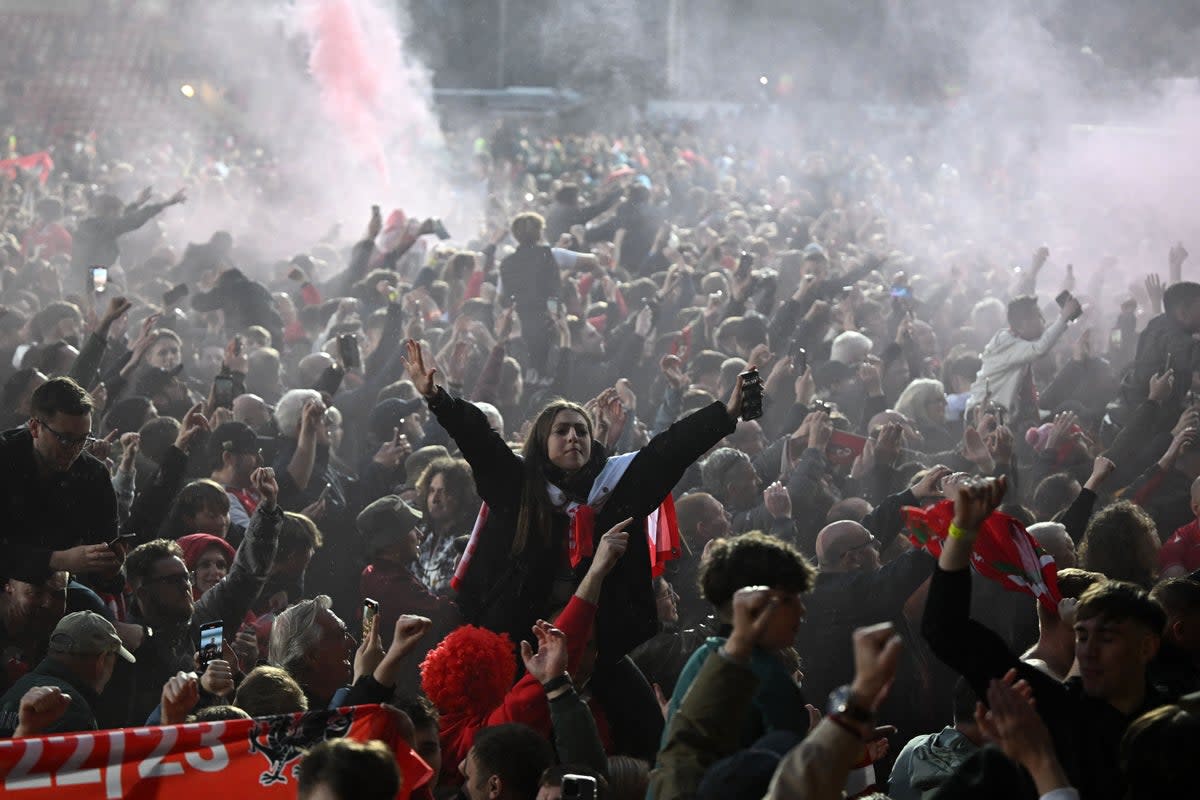 Champions: Wrexham sealed their return to League Two at the Racecourse Ground  (AFP via Getty Images)