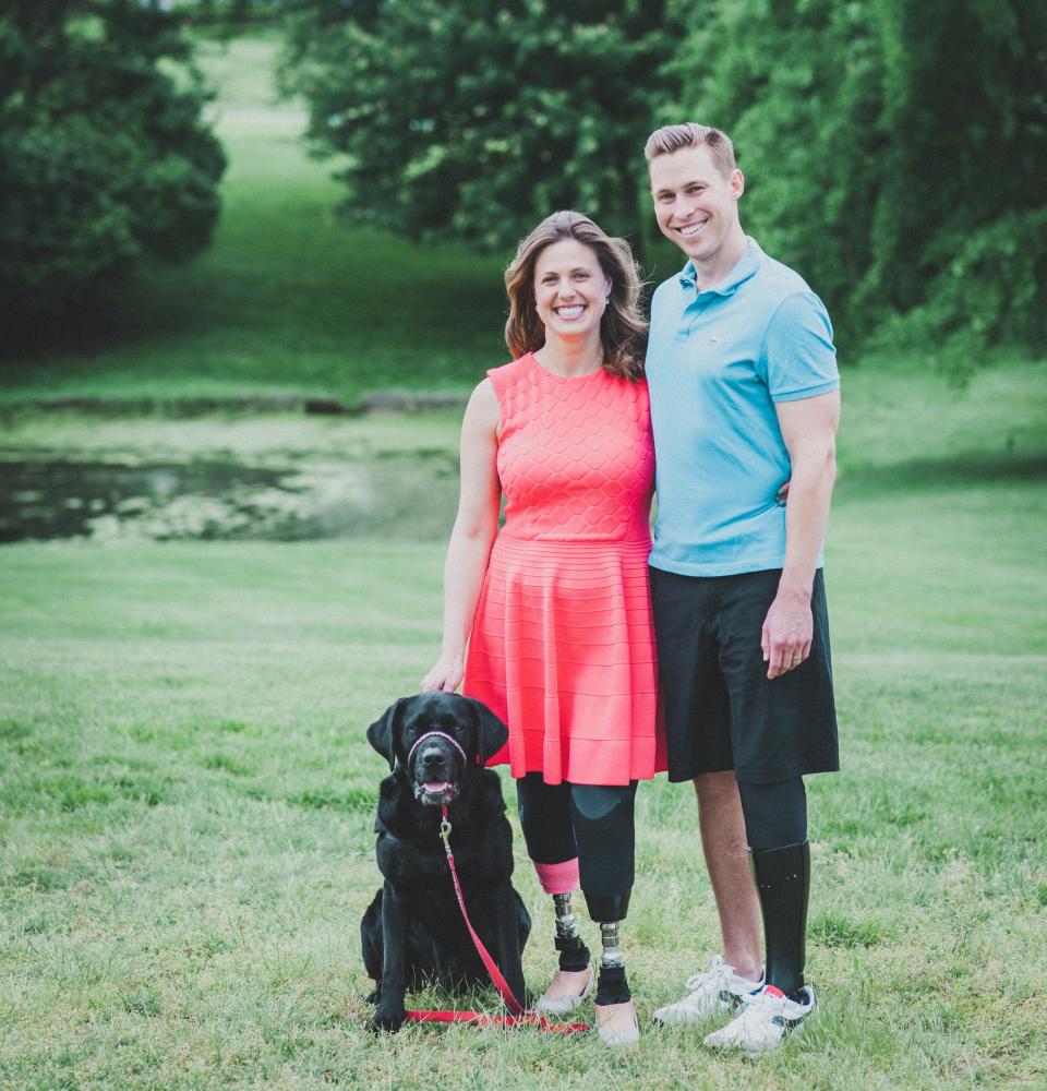 Jessica Kensky and Patrick Downes, who lost three legs between them in the blasts,&nbsp;pose with their support dog, Rescue. (Photo: Patrick Downes and Jessica Kensky)