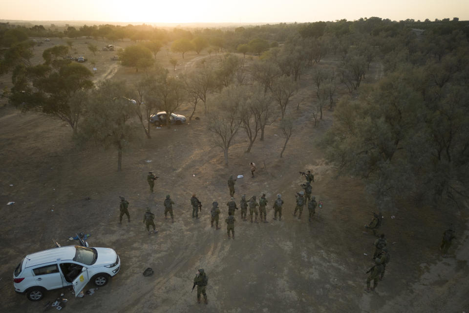 Israeli soldiers ordered a Palestinian who ran at them with a knife to undress at the site of a music festival near the border with the Gaza Strip on Thursday, Oct. 12, 2023. At least 260 Israeli festivalgoers were killed during the attack last Saturday. (AP Photo/Erik Marmor)