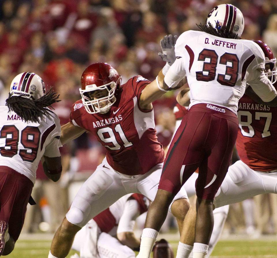 Nov 5, 2011; Fayetteville, AR, USA; Arkansas Razorback defensive end Jake Bequette (91) blocks South Carolina Gamecocks cornerback Marty Markett (39) and linebacker Damario Jeffery (33) during an extra point attempt at a game at Donald W. Reynolds Stadium. Mandatory Credit: Beth Hall-USA TODAY Sports