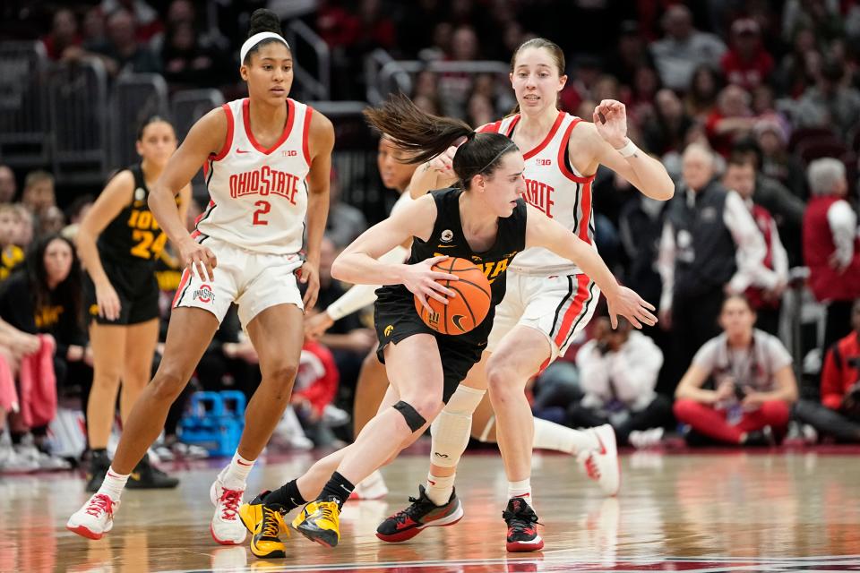 Iowa guard Caitlin Clark dribbles around Ohio State guard Taylor Mikesell during last year's matchup at Value City Arena.