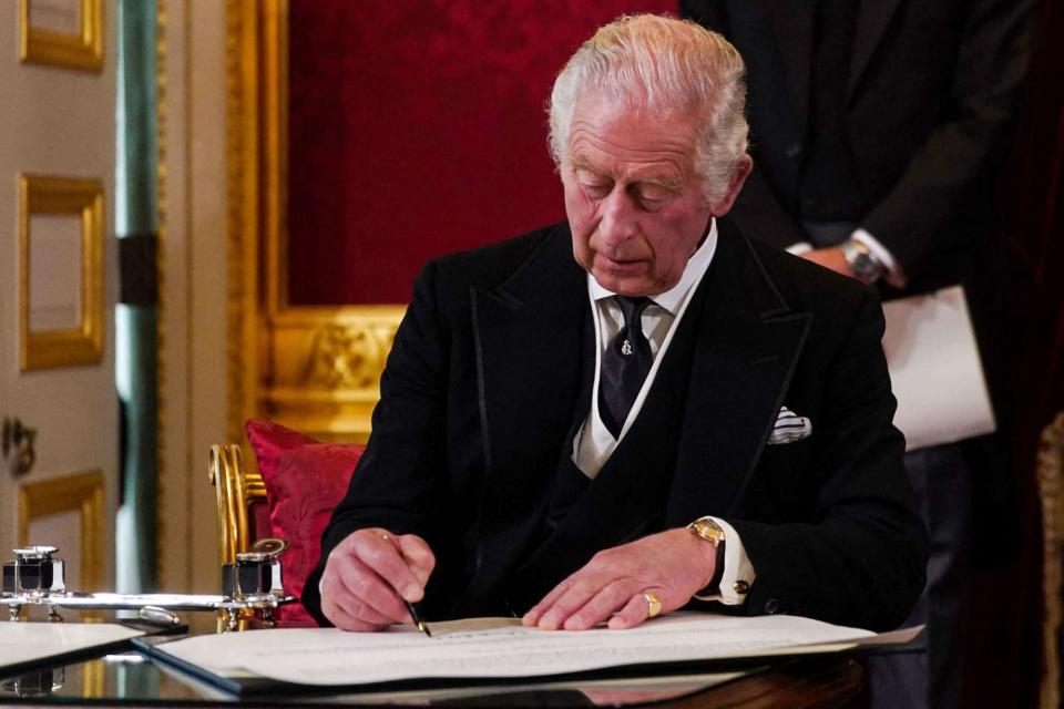  VICTORIA JONES/POOL/AFP via Getty King Charles signing an oath at the Accession Council on Sept. 10, 2022.