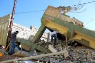 <p>Iraqi Kurdish men inspect a building destroyed in earthquake at Darbandikhan town, near Sulaymaniya city, northern Iraq, Nov. 13, 2017. (Photo: Abedin Taherkenareh/EPA-EFE/REX/Shutterstock) </p>