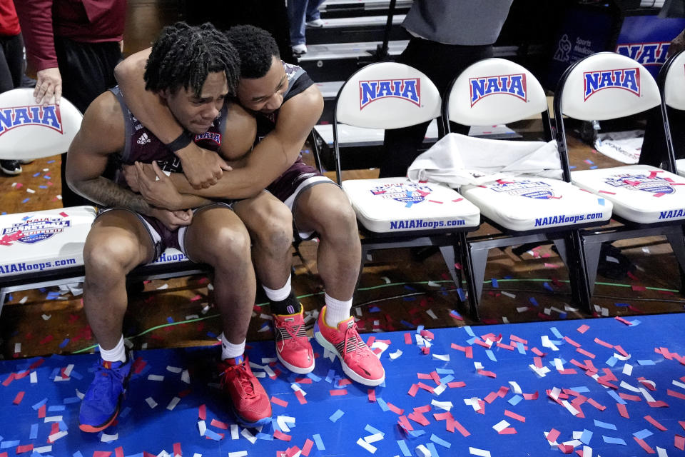 Freed-Hardeman guards Quan Lax, left, and JJ Wheat hug after their NAIA men's national championship college basketball game against Langston, Tuesday, March 26, 2024, in Kansas City, Mo. Freed-Hardeman won 71-67. (AP Photo/Charlie Riedel)