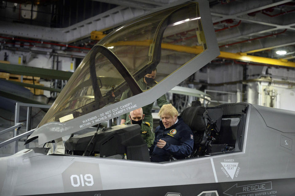 Britain's Prime Minister Boris Johnson sits in the cockpit of an Lockheed Martin F-35 Lightning II during a visit aboard HMS Queen Elizabeth in Portsmouth, England, Friday, May 21, 2021 ahead of its first operational deployment to the Far East. (Leon Neal/Pool Photo via AP)