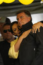 Brazilian President Jair Bolsonaro and his wife Michelle attend his re-election campaign rally in Juiz de Fora, Minas Gerais state, Brazil, Tuesday, Aug. 16, 2022. Bolsonaro formally began his campaign for re-election in this town where he was stabbed during his 2018 campaign. General elections are set for Oct. 2. (AP Photo/Silvia Izquierdo)