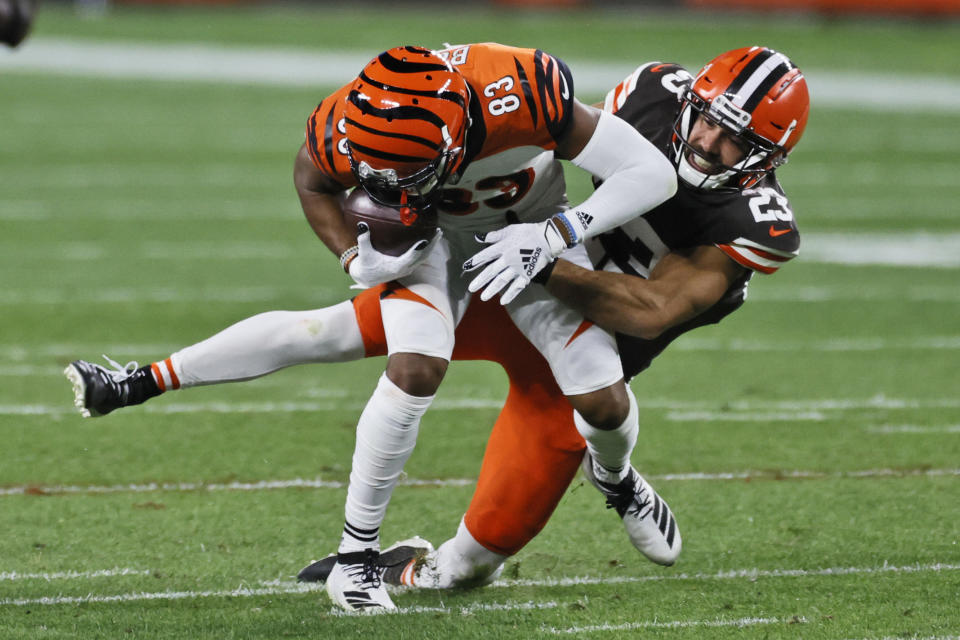 FILE - In this Thursday, Sept. 17, 2020 file photo, Cleveland Browns strong safety Andrew Sendejo (23) tackles Cincinnati Bengals wide receiver Tyler Boyd (83) after a pass reception during the second half of an NFL football game in Cleveland. The Cleveland Browns added starting safety Andrew Sendejo and rookie tight end Harrison Bryant to their lengthy COVID-19 list, Tuesday, Dec. 29, 2020. (AP Photo/Ron Schwane, File)