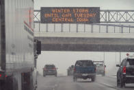 Traffic passes a sign warning of a winter storm, Monday, Jan. 25, 2021, in Des Moines, Iowa. A major winter storm is expected to blanket a large swath of the middle of the country with snow Monday and disrupt travel as more than a foot of snow falls in some areas. (AP Photo/Charlie Neibergall)