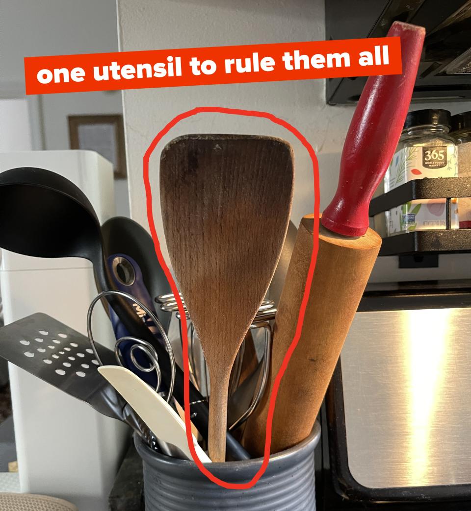 Wooden spatula in a utensil holder with text: "one utensil to rule them all"