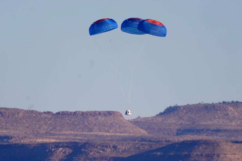Parachutes carry the Blue Origin's New Shepard capsule to the ground after liftoff from the spaceport near Van Horn, Texas, Saturday, Dec. 11, 2021. (AP Photo/LM Otero)