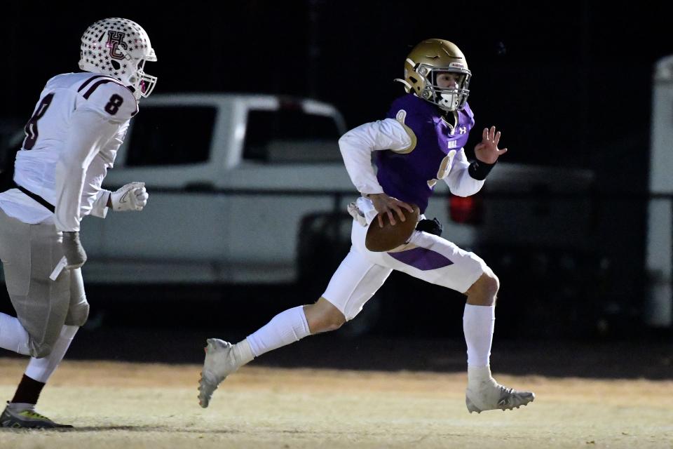 Male’s Lucas Cobler (9) is pursued by Henderson County's Saadiq Clements (8) during action of their 6A playoff game, Friday, Nov. 18 2022 in Louisville Ky.