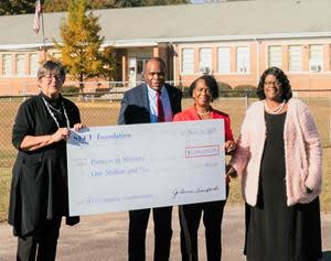 L to R: SECU Foundation Board Chair Jo Anne Sanford presents ceremonial check to Bishop Leonard Fairley,  Partners in Ministry (PIM) Executive Director Dr. Melba McCallum, and PIM Board Chair Reverend Gypsie Murdaugh.