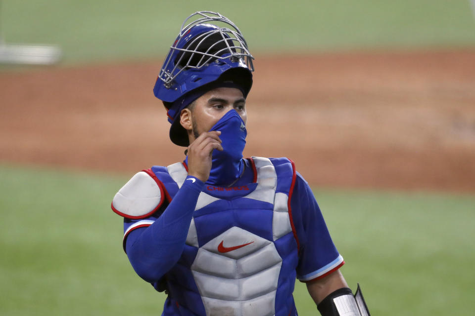 Texas Rangers catcher Robinson Chirinos adjusts his mask as he walks back to the dugout during a baseball practice at Globe Life Field in Arlington, Texas, Thursday, July 9, 2020. (AP Photo/Tony Gutierrez)