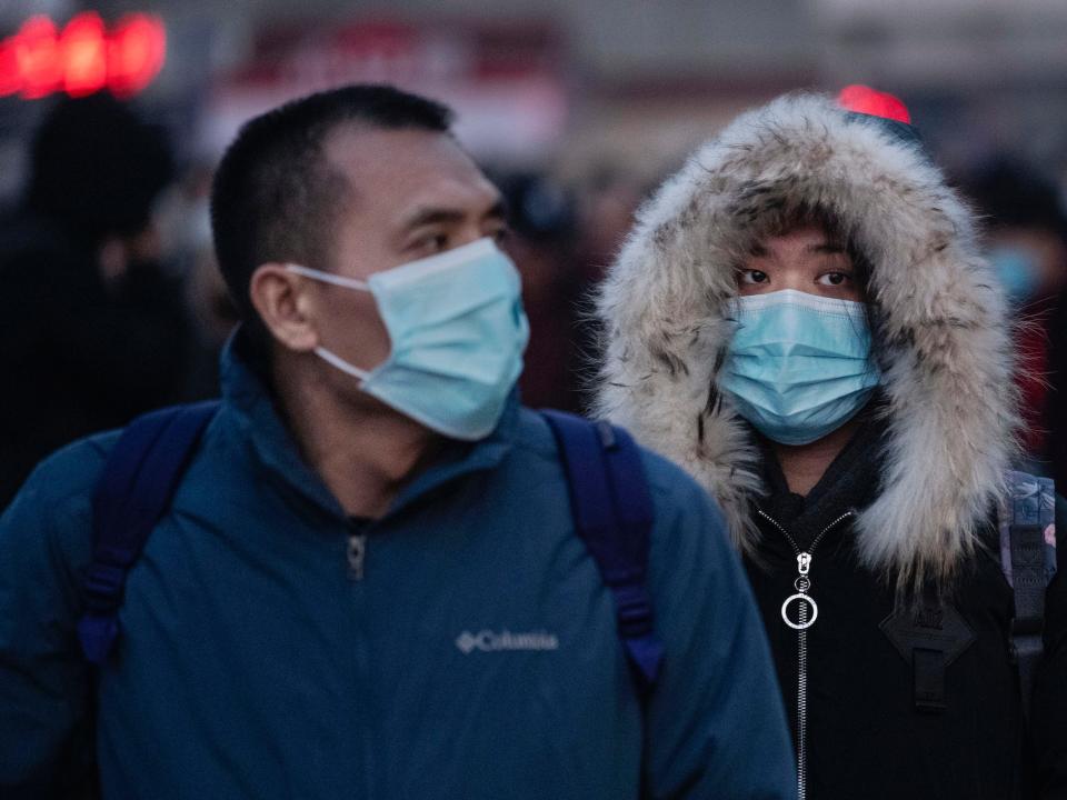 Chinese travellers wear protective masks as they arrive to board trains at Beijing Railway station before the annual Spring Festival on January 21, 2020 in Beijing, China.