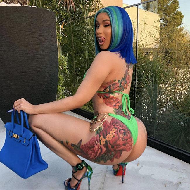 Cardi B showcases her huge back tattoos and side boob as she dons