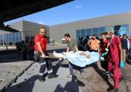 Nurses assist a Turkish worker injured in an explosion in Afgoye town, as he boards a Turkish military cargo plane at the Aden Abdulle International Airport in Mogadishu