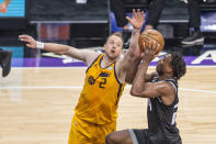 Utah Jazz guard Joe Ingles (2) defends Sacramento Kings guard Buddy Hield (24) as he goes to the basket during the first quarter of an NBA basketball game in Sacramento, Calif., Wednesday, April 28, 2021. (AP Photo/Hector Amezcua)