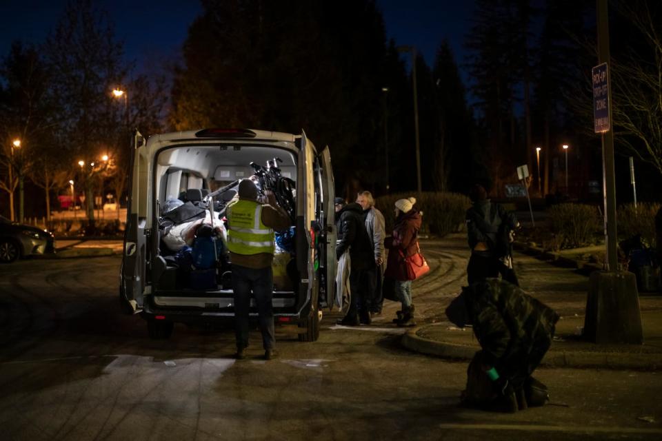 Upkar Singh Tatlay picks up unhoused people from an overnight shelter in Surrey, British Columbia to shuttle them to a daytime warming trailer in the neighbouring city of White Rock  on Monday, Jan. 15, 2024. 