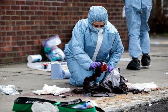 Forensics teams work at the scene of a stabbing in Edmonton, north London, in March last year (Getty Images)