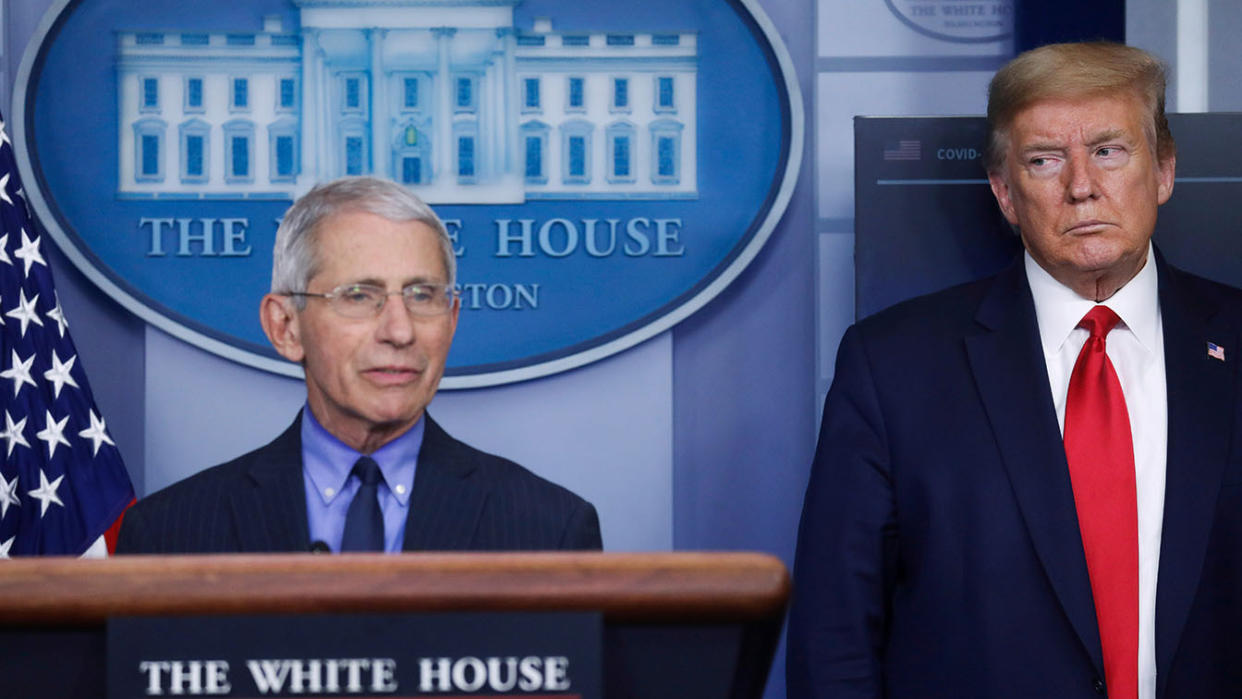 President Donald Trump looks on as Dr. Anthony Fauci answers a question at a coronavirus task force briefing in April 2020. (Leah Millis/Reuters)